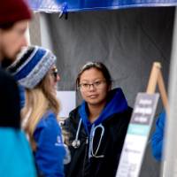 Guests mingle at Reunion Row and warm up at the heaters